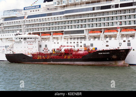 Southampton Docks England UK. August 2017. Bunkering vessel alongside a cruise ship pumping fuel Stock Photo