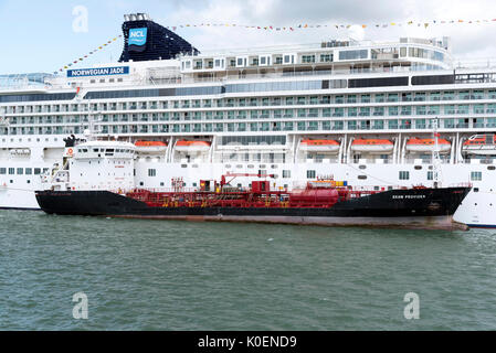 Southampton Docks England UK. August 2017. Bunkering vessel alongside a cruise ship pumping fuel Stock Photo