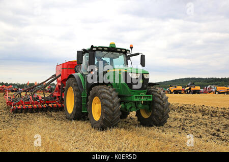 SALO, FINLAND - AUGUST 18, 2017: Farmer works with John Deere 6155R tractor and Vaderstad Spirit 600C seed drill Puontin Peltopaivat 2017 Agricultural Stock Photo