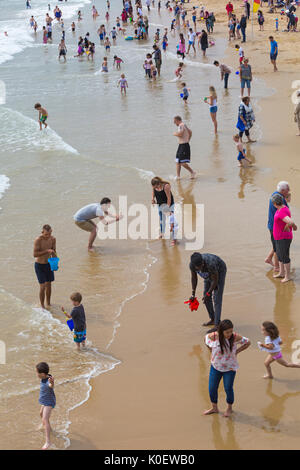 Bournemouth, Dorset, UK. 22nd Aug, 2017. UK weather: after a foggy start, mixed weather with sunshine and showers at Bournemouth beaches - the showers don't deter visitors from heading to the seaside. Credit: Carolyn Jenkins/Alamy Live News Stock Photo