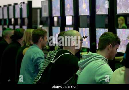 Cologne, Germany. 22nd Aug, 2017. Video gamers test a game at the Gamescom in Cologne, Germany, 22 August 2017. German Chancellor Merkel opens the video gaming fair Gamescom (22-26 August 2017). Photo: Oliver Berg/dpa/Alamy Live News Stock Photo