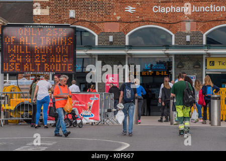 London, UK. 23rd August, 2017. Staff and signs warn passengers of a 75% reduction in service going through Clapham Junction on the Thursday 24th and Friday 25th August. This will be part of the ongoing disruption for commuters due to the Waterloo platform upgrade work in August. London 23 Aug 2017. Credit: Guy Bell/Alamy Live News Stock Photo