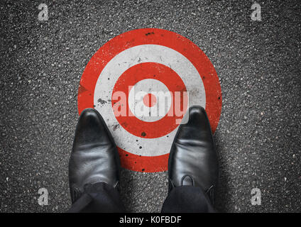 A businessman looking down at a target. Business concept. Stock Photo