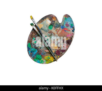 Artist's palette with brushes and oil paints isolated on white background Stock Photo