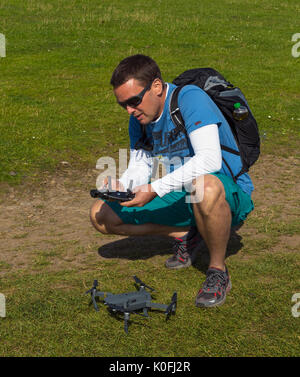 Man flying small drone Stock Photo