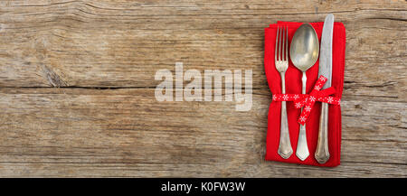 Table setting with fork, spoon and knife on wooden background Stock Photo