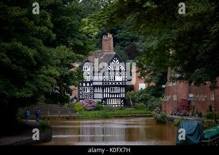 Salford's tudor style Packet House, Worsley in Manchester on the banks of the orange Bridgewater Canal Stock Photo