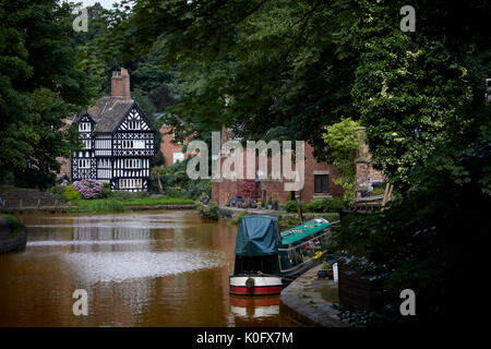 Salford's tudor style Packet House, Worsley in Manchester on the banks of the orange Bridgewater Canal Stock Photo