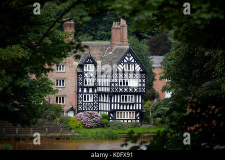 Salford's tudor style Packet House, Worsley in Manchester on the banks of the orange Bridgewater Canal Stock Photo