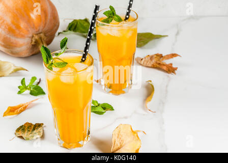 Fall and winter cold cocktails. Spicy pumpkin mojito with fresh mint, on white marble table. copy space Stock Photo