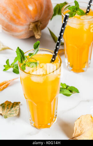 Fall and winter cold cocktails. Spicy pumpkin mojito with fresh mint, on white marble table. copy space Stock Photo