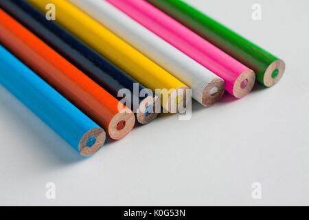 Close-up of a group of multicolored pencils on a white surface Stock Photo