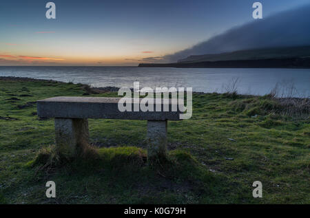 stone bench seat looking out to sea Stock Photo