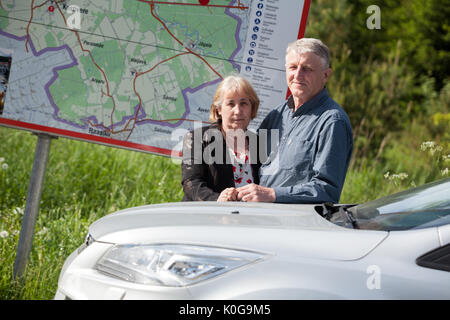 Mature people travel by car, standing near own car and map at summer season Stock Photo