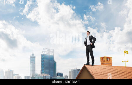 Mister boss on brick roof with arms akimbo. Mixed media Stock Photo