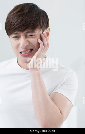 Portrait of man having toothache Stock Photo