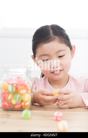 Portrait of smiling girl with candies Stock Photo