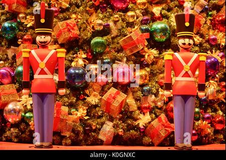 Nutcracker Christmas holiday decorations with glass bulbs, presents, ornaments and tinsel on Christmas tree at Winter WonderFest at Chicago Navy Pier. Stock Photo