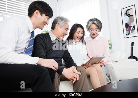 Harmonious family sharing a tablet Stock Photo