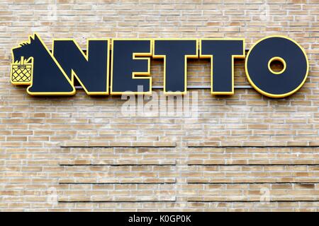 Malling, Denmark - August 19, 2017: Netto sign on a wall. Netto is a Danish discount supermarket operating in several European countries. Stock Photo