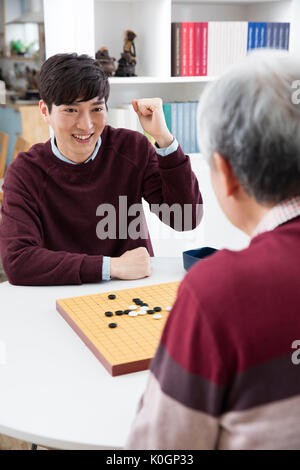 Portrait of young smiling man and senior man cheering Stock Photo