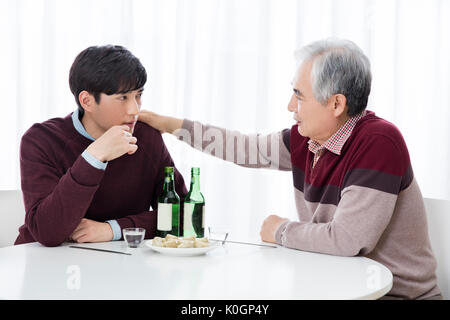 Portrait of young man and his senior father drinking Stock Photo
