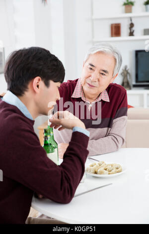 Portrait of senior father and his young son drinking Stock Photo