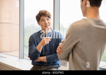 Two smiling businessmen having a meeting Stock Photo