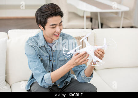 Smiling male kidult playing with drone Stock Photo