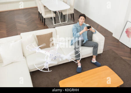 Smiling male kidult playing with drone Stock Photo