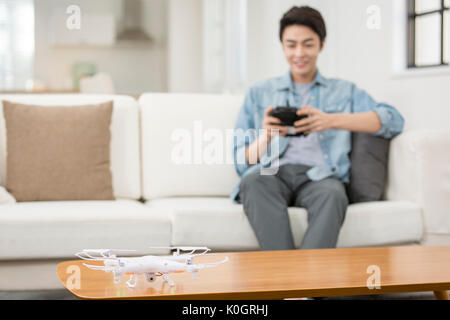 Smiling male kidult playing with drone Stock Photo