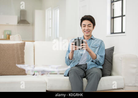 Smiling male kidult playing with drone Stock Photo