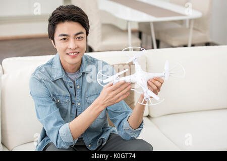 Smiling male kidult playing with drone Stock Photo