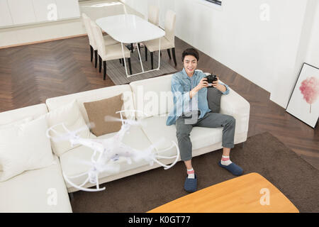 Smiling male kidult playing with drone Stock Photo