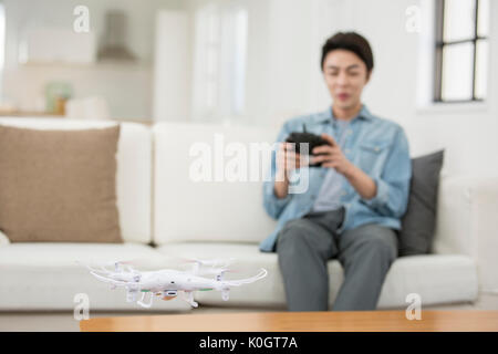 Smiling male kidult playing with drone Stock Photo