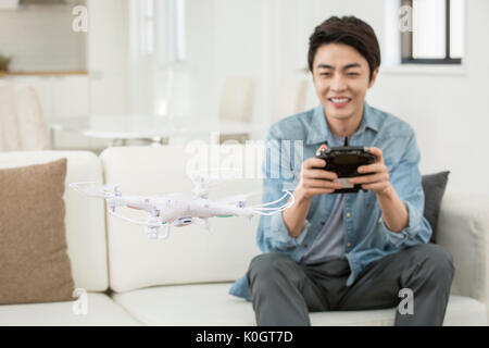 Smiling male kidult playing with drone Stock Photo