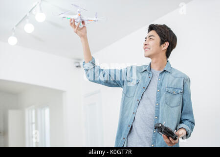 Smiling male kidult playing with drone Stock Photo