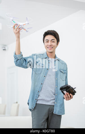 Smiling male kidult playing with drone Stock Photo
