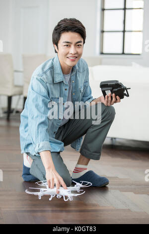 Smiling male kidult playing with drone Stock Photo
