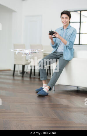 Smiling male kidult playing with drone Stock Photo