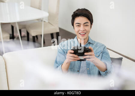 Portrait of smiling male kidult playing with drone Stock Photo