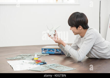 Side view of smiling male kidult playing with toy Stock Photo