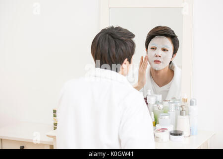 Portrait of grooming putting on beauty mask pack Stock Photo