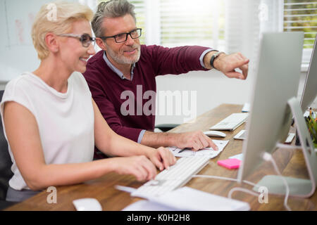 White collar workers working on computers Stock Photo