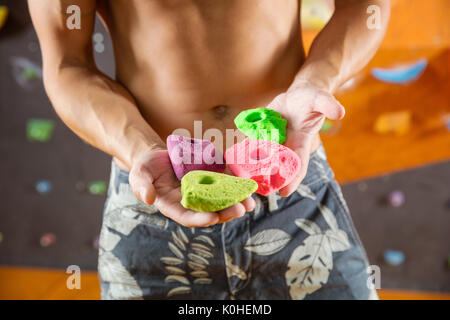Rock climber demonstrating new bolt-on climbing holds Stock Photo