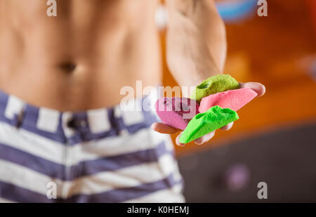 Rock climber demonstrating new bolt-on climbing holds, selective focus Stock Photo