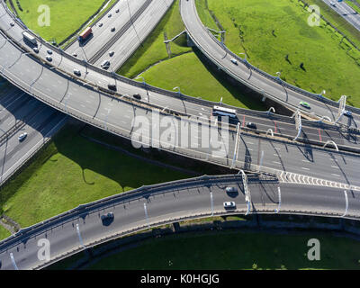 Multi-level interchange of city ringroad with driving vehicles. Aerial view. St. Petersburg, Russia Stock Photo