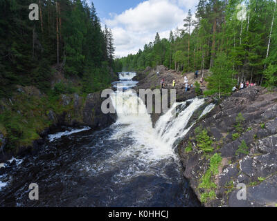 KARELIA, RUSSIA-CIRCA JUL, 2017: People are on rocky riverbed of the Kivach Fall on the river Suna. The Kivach is a state nature reserve is opened for Stock Photo