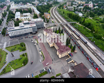 PETROZAVODSK, KARELIA, RUSSIA-CIRCA JUL, 2017: Passenger train stands on platform of train station. Buildings are on the Gagarin square. Top view. Cit Stock Photo