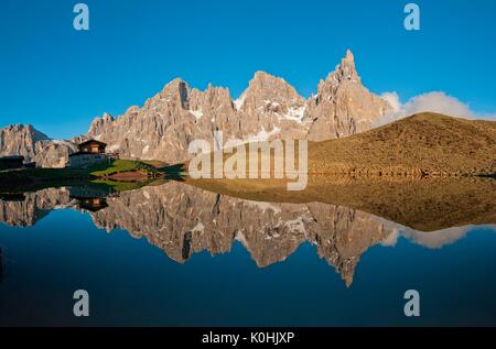 Passo Rolle, Dolomites, Trentino, Italy. The mountaingroup of Pala di San Martino  reflecting in the lake near Segantini Hut. From left Mulaz, Cima de Stock Photo